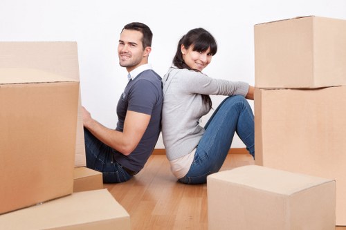 Professional movers loading furniture into a removal truck