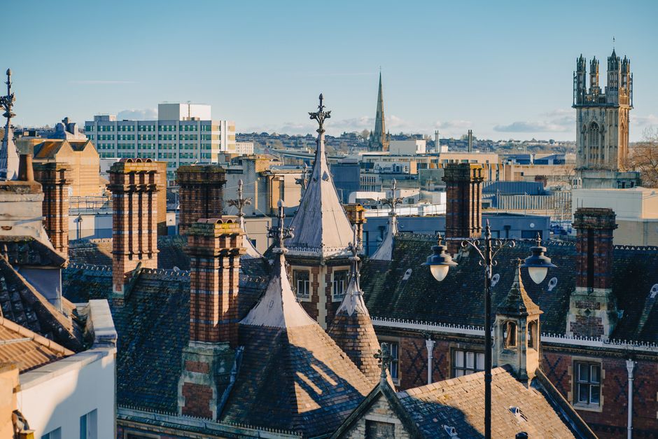 The image displays the upper section of a historic residential building in Crystal Palace, featuring a rounded turret with a decorative metal spire on top, set against a bright blue sky with scattered